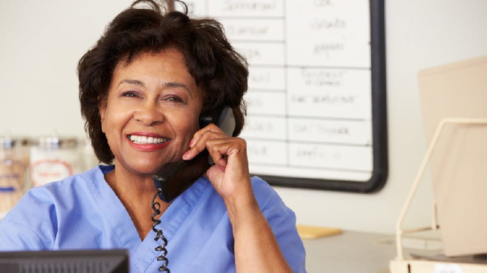 Retirement planning tips nurse smiling on phone